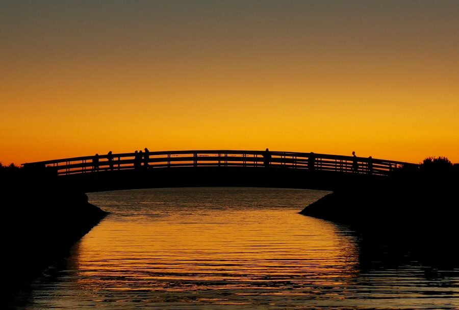 a bridge over a body of water at sunset